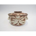 GODFREY ARNISON (XX): A studio pottery lidded casserole, wax resist leaf detail.