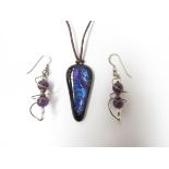 A Murano glass pendant on cord, irredescent blues, purples,