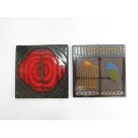 Two decorative art pottery tiles, one with red abstract design,