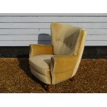 A Danish 1940's armchair with original olive velour upholstery raised on tapering round legs