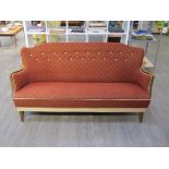 A Danish 1940's three seater sofa, stained beech arms, original terracotta and cream upholstery,