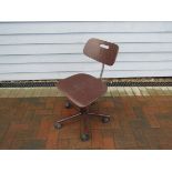 A brown painted ply and metal desk chair,