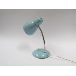 A powder blue painted adjustable desk lamp