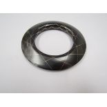 A metal bangle with niello line detail,