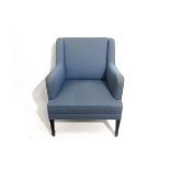 A Danish 1940's winged backed armchair with blue upholstery,