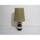 A West German treacle and beige glazed pottery table lamp with hessian type shade.