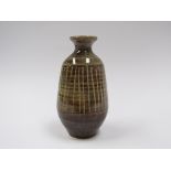 A studio pottery bottle vase with ash glaze and vertical line detail. Incised marks to base.