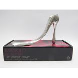 A boxed Manolo Blahnik shoe horn plus Piper Heidsieck champagne stiletto heel shoe