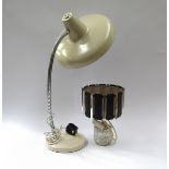 A cream painted metal desk lamp and a glass based table lamp.