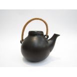 An Arabia teapot, cane handle, designed by Ulla Procope,