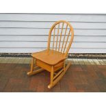 An Ercol child's rocking chair model no.