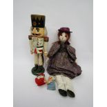 A painted composition girl doll,