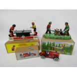 Three modern boxed tinplate toys- racing car,