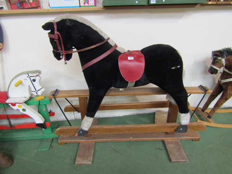 A soft filled rocking horse on oak trestle rocker,