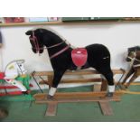 A soft filled rocking horse on oak trestle rocker,