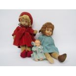 A painted cloth doll in red outfit,