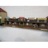 A wooden toy American Western street arcade with cowboys and Indians plastic figures