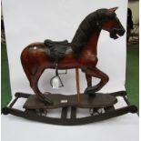 A Victorian style carved wooden push along horse mounted on a bowed rocker