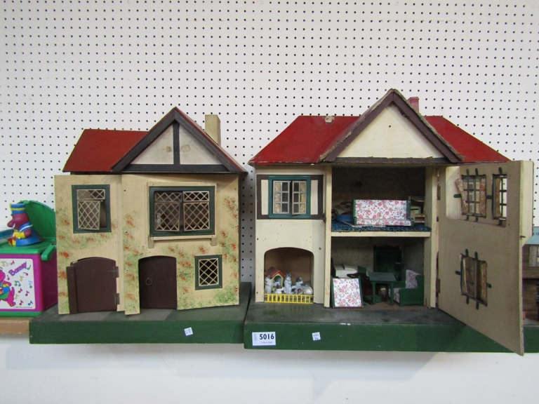 A Tri-Ang two storey dolls house containing furniture and figures and another similar