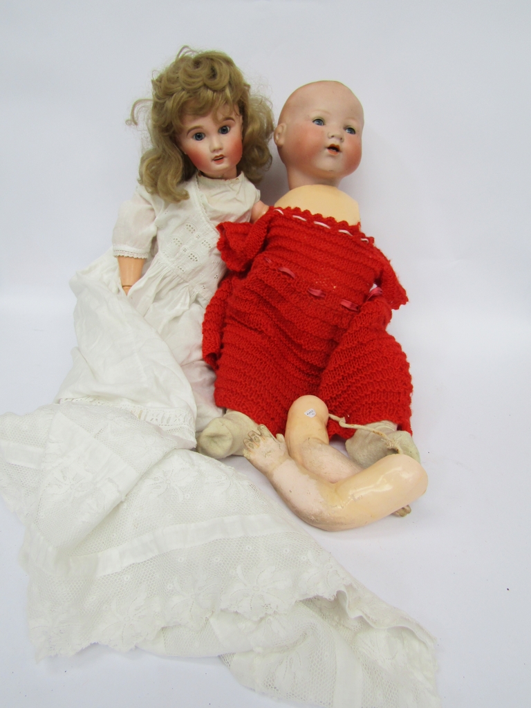 An Armand Marseille 351 bisque head baby doll on jointed compostion body and a French bisque doll