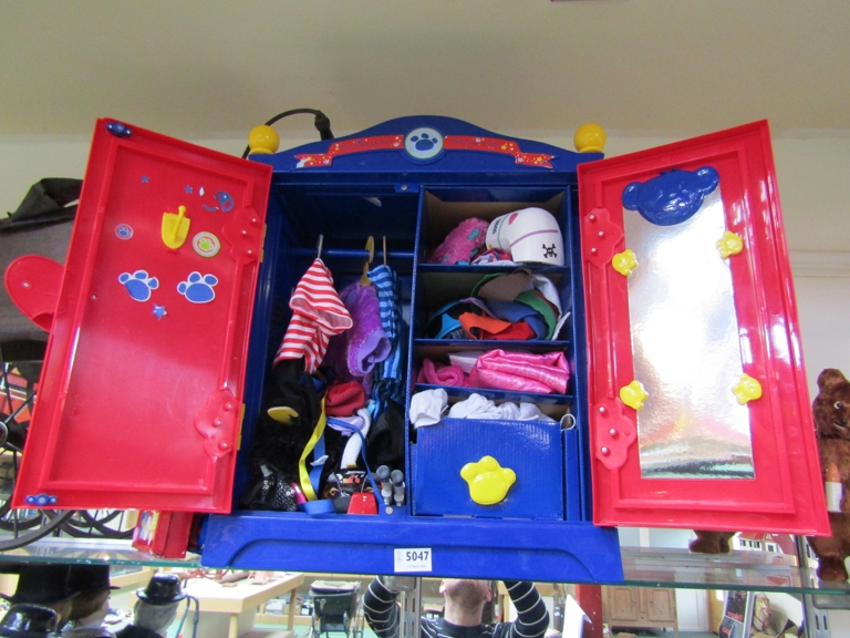 A Build a Bear wardrobe containing clothes amd accessories