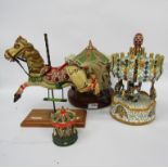 Three model carousels and a model carousel horse