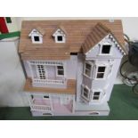 A wooden two storey dolls house