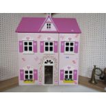 A two storey dolls house and a quantity of furniture