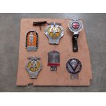 Six mounted car badges including AA,