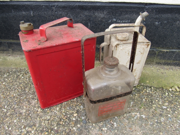 Two fuel cans and a glass stove fuel bottle