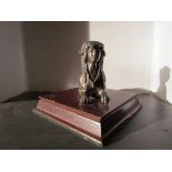 Sphinx mascot mounted on a wooden base