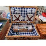 A wicker picnic basket with contents