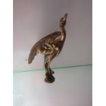 A brass bird mascot