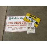 A tin sign "Holiday Inn Guest Parking Only" and two Mustang tin signs