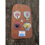 A board containing five auto badges and a Rover key fob, British Automobile Racing Club No 3459,