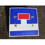 An enamelled road sign with brackets