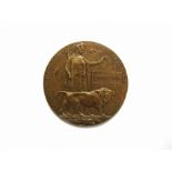 A WWI Memorial plaque / bronze death penny named to Thomas Hall