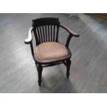 A 1940's oak military desk chair with slatted back, upholstered seat, on H-stretcher base,