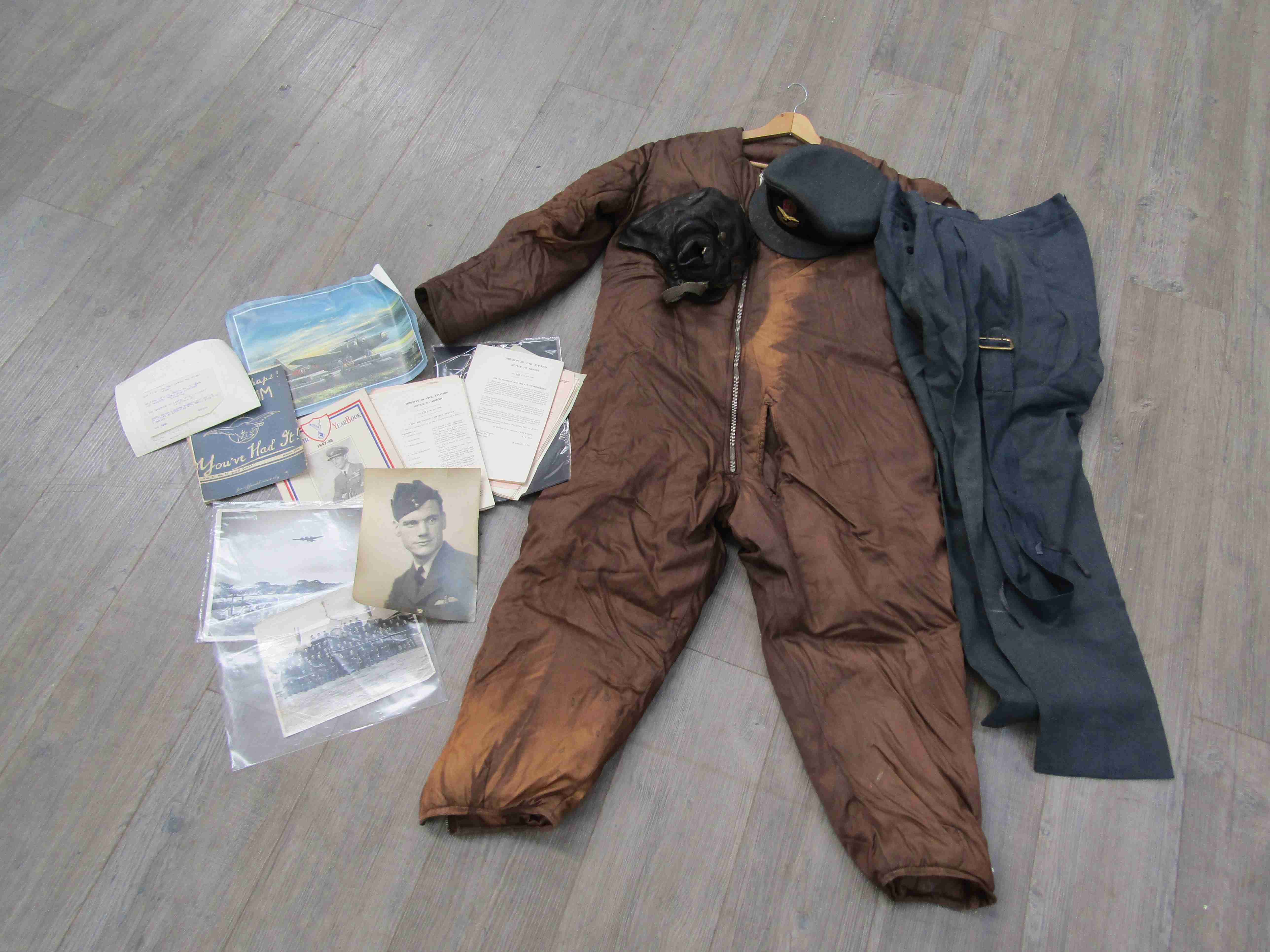 An RAF pilot's uniform with jacket, trousers and hat with King's crown badges and buttons,