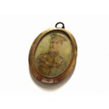 A WWI era hand painted locket with Scottish Regiment Serviceman and officer portraits,