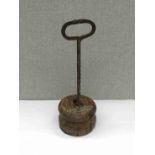 A turned oak and twisted wrought iron doorstop with H.M.