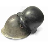 A WWII German M42 helmet shell, blackened,
