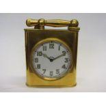 An early 20th Century gilt brass desk timepiece/table lighter, Arabic enamelled dial, 8 day