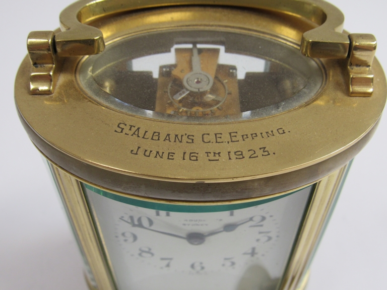 An early 20th Century brass and onyx cased French single train carriage timepiece of oval form. - Image 3 of 5