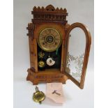 An early 20th Century 'Gilbert Altai' oak gingerbread style mantel clock with strike and alarm