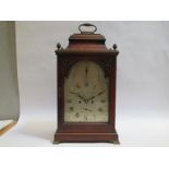 A George III mahogany bracket clock with bell top, the silvered brolan arched dial with calendar and