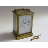 A late 19th Century brass cased striking carriage clock with Roman enamelled dial, possibly later