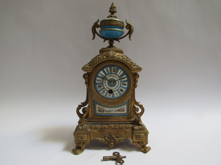 A mid to late 19th Century French ormolu timepiece with rococo motifs, hand painted and gilt