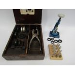 A collection of watchmaker's tools including mainspring winders, UB crystal inserting tool with
