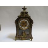 A 19th Century French boulle work mantel clock with decorative ormolu mounts, feet and finial,
